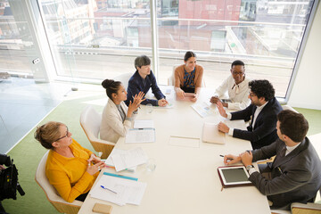 Business people discussing paperwork in conference room
