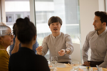 Business people eating sushi lunch in conference room