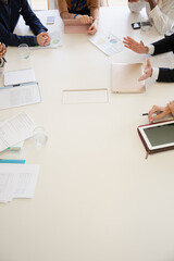 Paperwork and electronics on conference room table