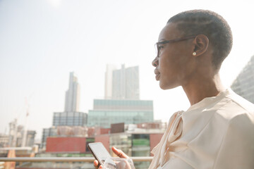 Portrait of businesswoman enjoying view from balcony