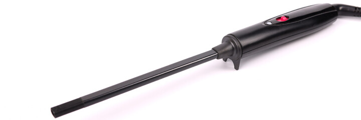 Black hair curling iron lying on white background closeup