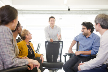 Business people meeting at computer in open plan office