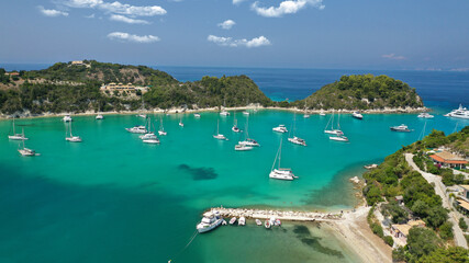 Fototapeta premium Aerial drone photo of iconic port and fishing village of Lakka or Laka with traditional Ionian architecture a safe anchorage for sail boats and yachts, Paxos island, Ionian, Greece