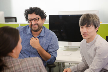 Business people talking in open plan office