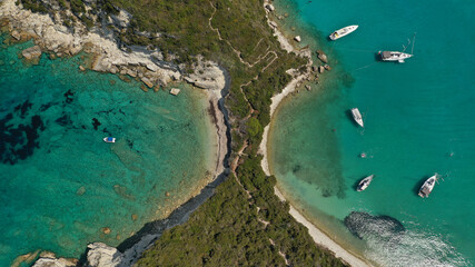 Aerial drone photo of luxury yachts and sail boats anchored in tropical exotic island emerald bay with crystal clear calm sea