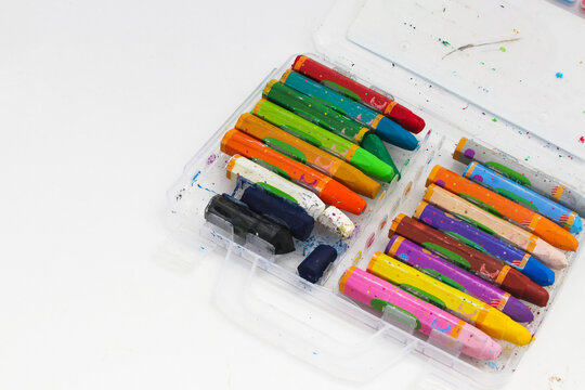 Old used colored crayons for drawing isolated on a white background. Concept of Creativity, young artist, and back to school.