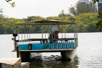 Fototapeta premium View of the Marapendi lagoon with buildings in the background and ferry boats waiting for passengers. Viewed from inside another boat on the lagoon. Located near Praia da Reserva in Rio de Janeiro
