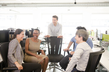 Business people meeting at computer in open plan office