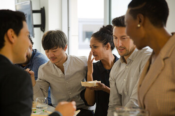 Happy business people enjoying sushi lunch