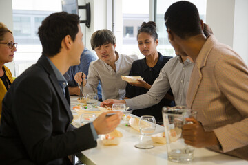 Happy business people enjoying sushi lunch