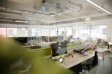 Business people talking in open plan office