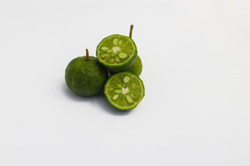 Lime or Limau (Citrus amblycarpa) isolated on white background. Used for spice in cooking, Lime or Limau (Citrus amblycarpa) is one of the native Citrus species of West Java, Indonesia.