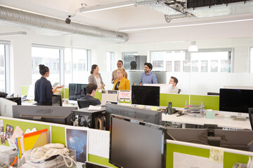 Businesswoman using tablet computer in open plan office