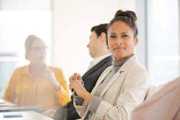 Portrait of smiling businesswoman in conference room meeting
