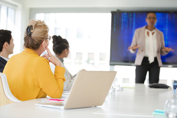 Businesswoman leading conference room meeting