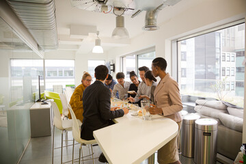 Happy business people enjoying sushi lunch