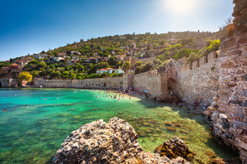 Beautiful Mediterranean Sea beach against the city walls of Alanya, Turkey