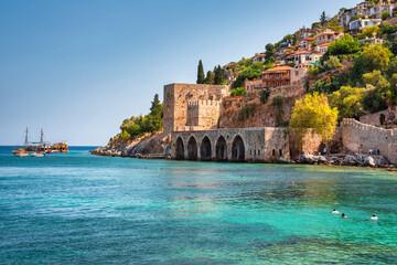 Beautiful Mediterranean Sea beach against the city walls of Alanya, Turkey