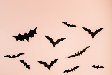 Halloween concept. Bats and spiders on pink background. Festive decorations.