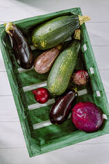 vegetables in a wooden box on a light background in a rustic style
