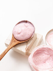 Pink body scrub in wooden spoon. Natural cosmetic