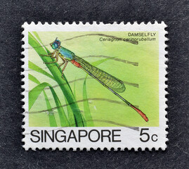 Cancelled postage stamp printed by Singapore, that shows Damsel fly, circa 1985.