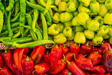 Mix of chili peppers, bell peppers, capi color assortment on vegetable market.