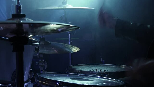 Musician is playing drums on stage, drummer.