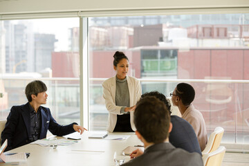Businesswoman leading conference room meeting