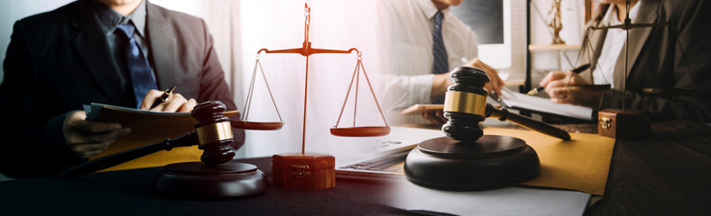 Justice and law concept.Male judge in a courtroom with the gavel, working with, computer and...