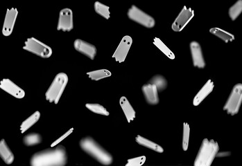 white ghosts fly on a black background
