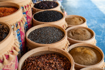 Assortment of Turkish spices and herbs in wooden bowls. Turkish market spices such as saffron, sumac and thyme. Cumin, rosemary and isot.
