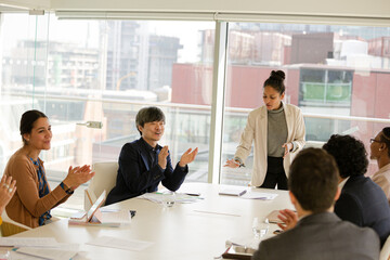 Businesswoman leading conference room meeting