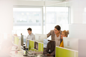 Business people brainstorming in open plan office