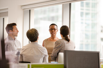 Fototapeta premium Business people talking in open plan office