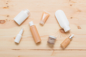 Natural cosmetic products on a light wooden. Mockup of cosmetic bottles.