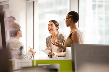 Business people talking in open plan office