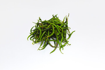 a bunch of fresh curly green chilies (Cabai Merah Keriting) isolated on white background. Selective focus of Hot chili pepper stock images. Agriculture background.