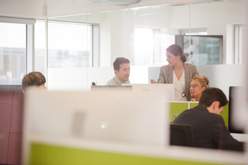 Business people brainstorming in open plan office