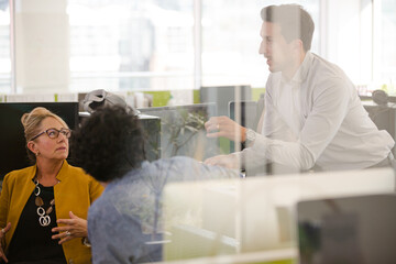 Business people brainstorming in open plan office