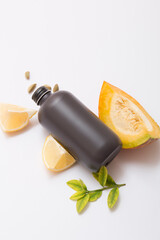 Natural cosmetic products on a light background. Black cosmetic bottle mockup.