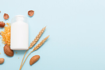 Natural cosmetic products on a blue background. White cosmetic bottle mockup.