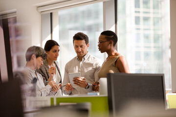 Business people talking in open plan office