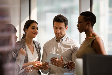 Business people talking in open plan office