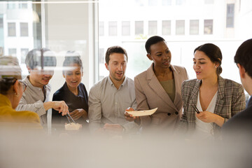 Business people enjoying sushi lunch in conference room
