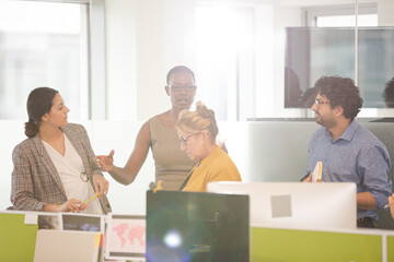 Business people talking in open plan office