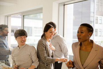 Smiling business people leaving conference room