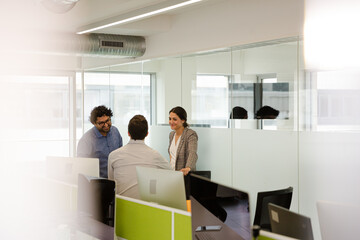 Business people talking in open plan office