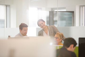 Business people brainstorming in open plan office