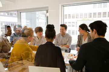 Business people enjoying sushi lunch